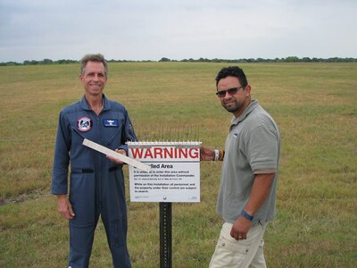 David Bernacki, 12th Training Squadron Introduction to Fighter Fundamentals simulator/academic instructor supervisor, and Mike Pacheco, 12th Flying Training Wing Safety Office wildlife biologist, display Bernacki’s patent-pending Anti-Bird Perch Attachment for Signs, or ABPAS, at Joint Base San Antonio-Randolph. The attachment mounts on signs to hold bird spikes used in the Bird Aircraft Strike Hazard program. Bernacki is the Air Education and Training Command winner of the 2019 Air Force Association Lisa S. Disbrow Outstanding Civilian of the Year Award. Courtesy photo.