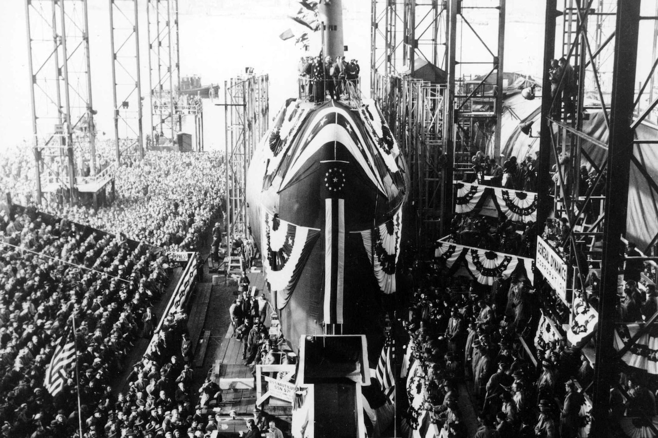 A crowd surrounds a submarine.