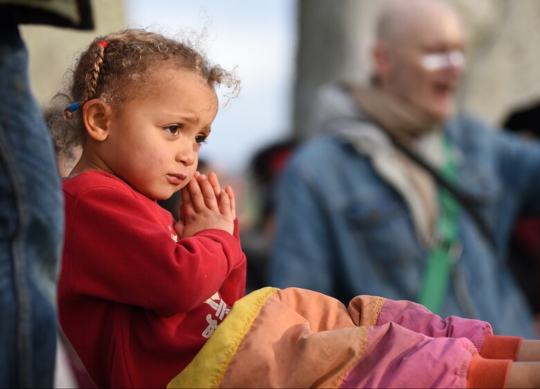 A child claps along with music during the winter solstice celebration at Stonehenge, England, Dec. 22, 2018. The stone circle at Stonehenge has silently marked the winter solstice for thousands of years. (U.S. Air Force photo by Airman 1st Class Madeline Herzog)