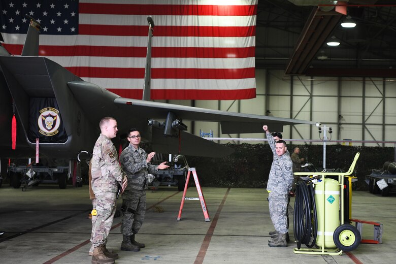 A 748th Aircraft Maintenance Squadron load crew member pumps his fist in the air in response to cheers from the audience at the 48th Fighter Wing 2018 Load Crew of the Year competition at Royal Air Force Lakenheath, England, Jan. 18, 2019. The 48th and 748th AMXS sent their best load crew teams to see which would walk away the champion team of the Liberty Wing. (U.S. Air Force photo by Airman 1st Class Shanice Williams-Jones)