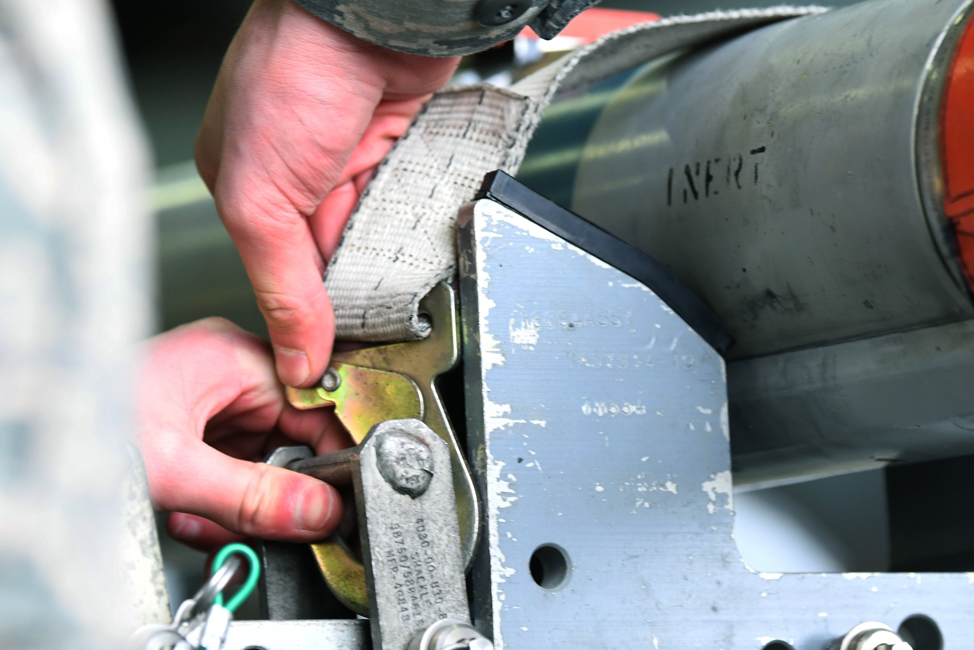 A 748th Aircraft Maintenance Squadron load crew member secures ordinance at the 48th Fighter Wing 2018 Load Crew of the Year competition at Royal Air Force Lakenheath, England, Jan. 18, 2019. The 492nd, 493rd and 494th Aircraft Maintenance Units were given 30 minutes to complete a demonstration load. (U.S. Air Force photo by Airman 1st Class Shanice Williams-Jones)