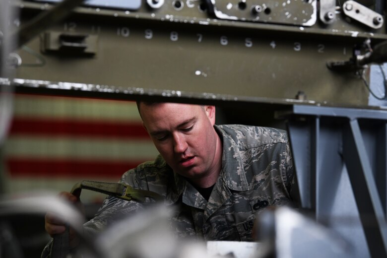 A 748th Aircraft Maintenance Squadron load crew member secures ordinance at the 48th Fighter Wing 2018 Load Crew of the Year competition at Royal Air Force Lakenheath, England, Jan. 18, 2019. The load crew teams were judged on their ability to load both an inert MK-82 and a GBU-38 on the aircrafts. (U.S. Air Force photo by Airman 1st Class Shanice Williams-Jones)