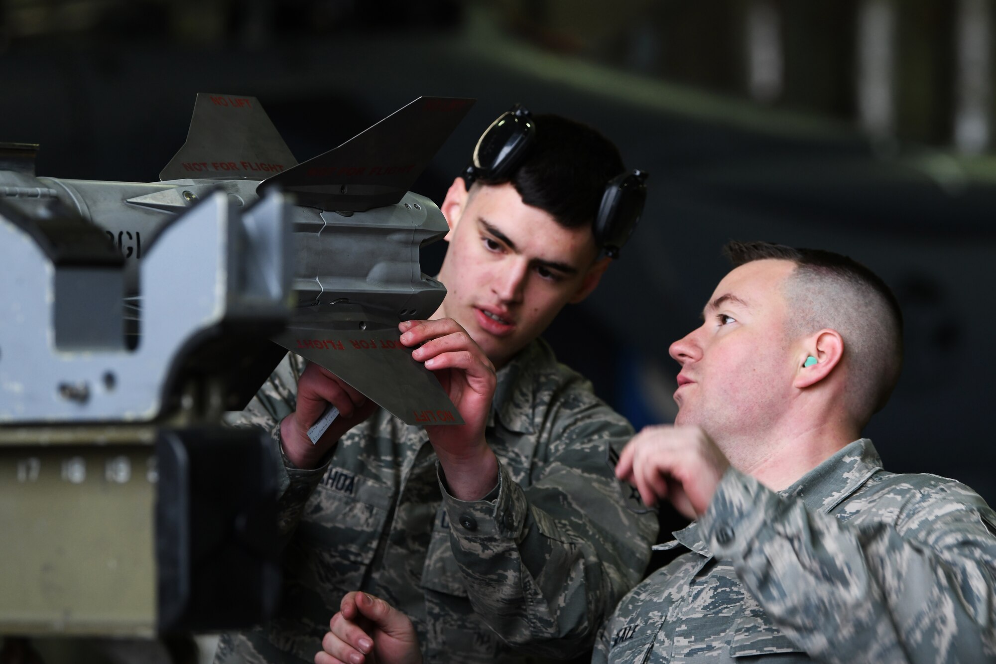 493rd weapons load crew members check an inert bomb during the 48th Fighter Wing 2018 Load Crew of the Year competition at Royal Air Force Lakenheath, England, Jan. 18, 2019.  The competition was a great opportunity for load crew members to test their skills and strengthen their teamwork. (U.S. Air Force photo by Airman 1st Class Shanice Williams-Jones)