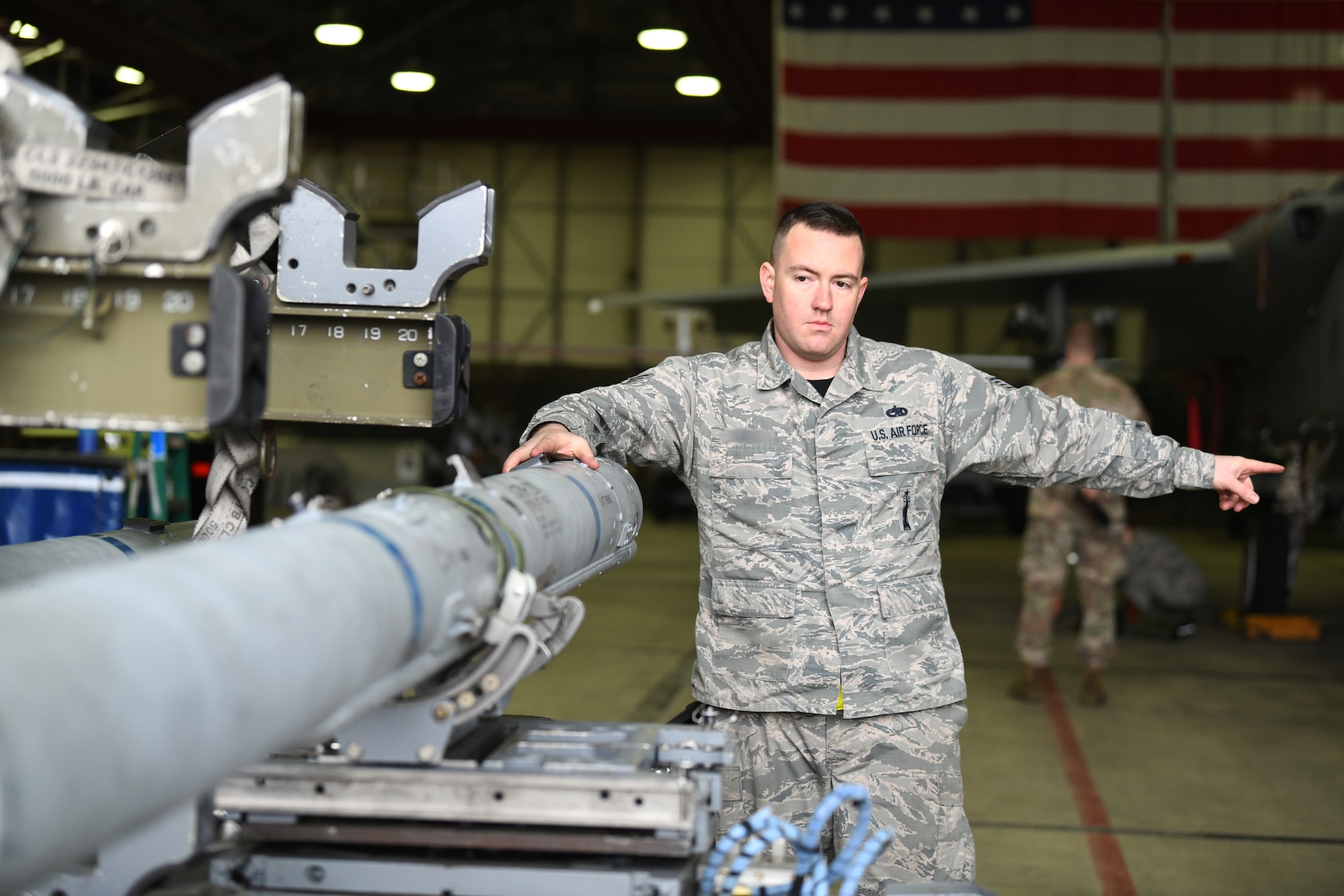 A 493rd weapons load crew member guides ordinance to an aircraft during the 48th Fighter Wing 2018 Load Crew of the Year competition at Royal Air Force Lakenheath, England, Jan. 18, 2019. The winner will go on to compete at the U.S. Air Forces in Europe and Air Forces Africa level Load Crew competition. (U.S. Air Force photo by Airman 1st Class Shanice Williams-Jones)