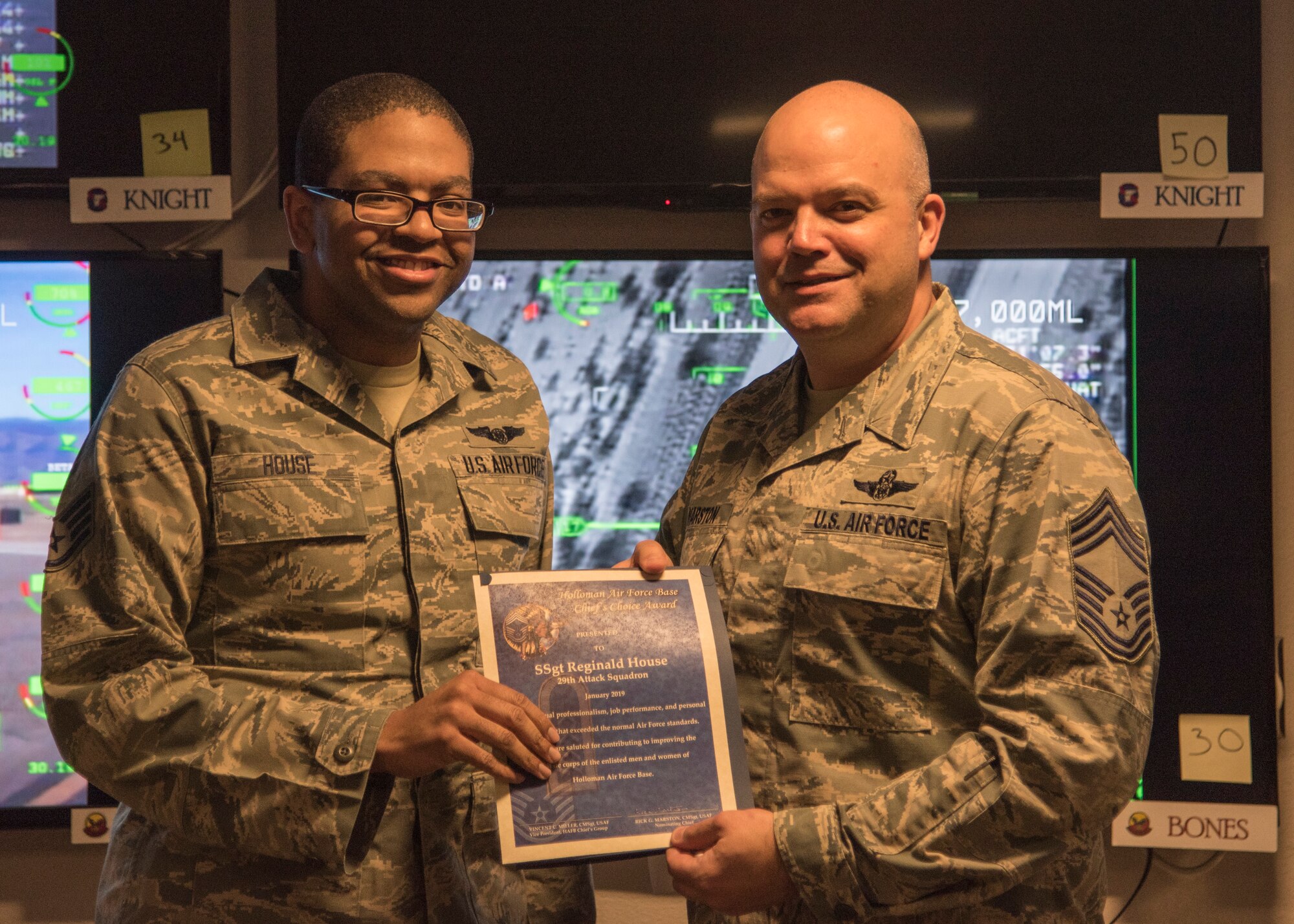 Staff Sgt. Reginald House, Remotely Piloted Aircraft sensor operator instructor, receives the Chief’s Choice Award from Chief Master Sgt. Rick Marston, 49th Operations Group superintendent, Jan. 17, 2019, on Holloman Air Force Base, N.M. Holloman’s Chiefs Group has a monthly recognition program titled Chief’s Choice Award. Every month, a chief has the honor of choosing a deserving Airman for an outstanding act or for continuous oustanding performace. (U.S. Air Force photo by Airman 1st Class Kindra Stewart)