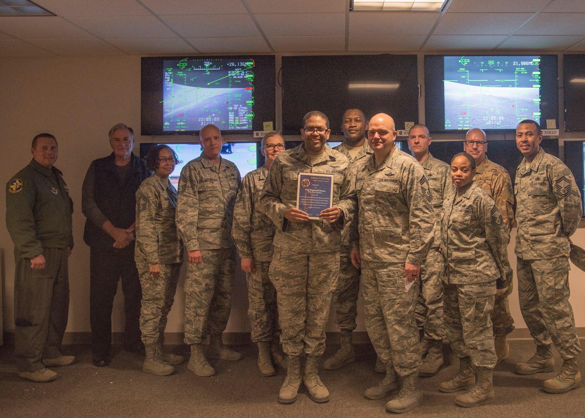 Staff Sgt. Reginald House, Remotely Piloted Aircraft sensor operator instructor, receives the Chief’s Choice Award from Chief Master Sgt. Rick Marston, 49th Operations Group superintendent, Jan. 17, 2019, on Holloman Air Force Base, N.M. Holloman’s Chiefs Group has a monthly recognition program titled Chief’s Choice Award. Every month, a chief has the honor of choosing a deserving Airman for an outstanding act or for continuous oustanding performace. (U.S. Air Force photo by Airman 1st Class Kindra Stewart)