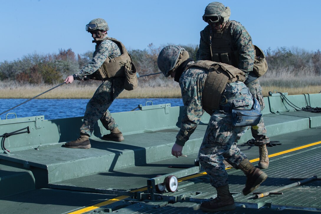 U.S. Marines with Bridge Company, 8th Engineer Support Battalion, 2nd Marine Logistics Group, construct an Improved Ribbon Bridge during a company-level field exercise at Camp Lejeune, North Carolina., Jan. 15, 2019.  Bridge Company conducted the exercise to sustain mission essential training and standards, and rehearse alternative methods of employing equipment to support infantry units. (U.S. Marine Corps photo by Lance Cpl. Damion Hatch Jr)