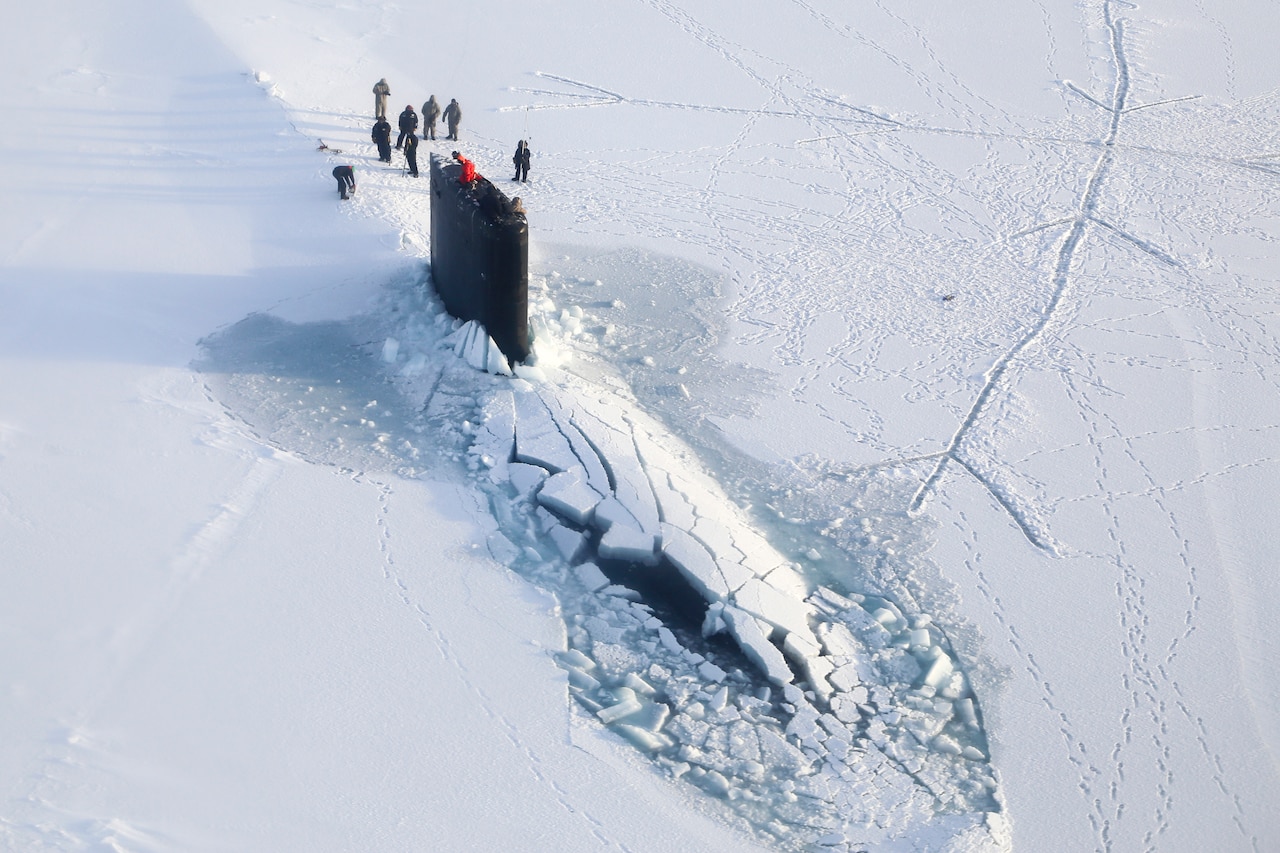 A submarine surfaces through ice.