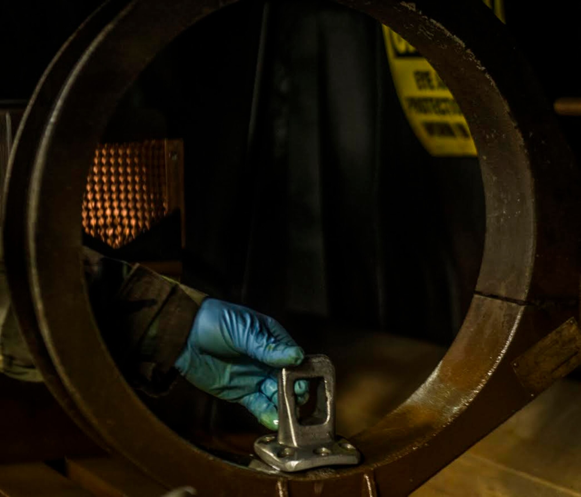 U.S. Air Force Airman 1st Class Colin Lanterman, 20th Equipment Maintenance Squadron non-destructive inspection apprentice, places a metal part in a stationary magnetic particle unit at Shaw Air Force Base, S.C., Jan. 15, 2019.