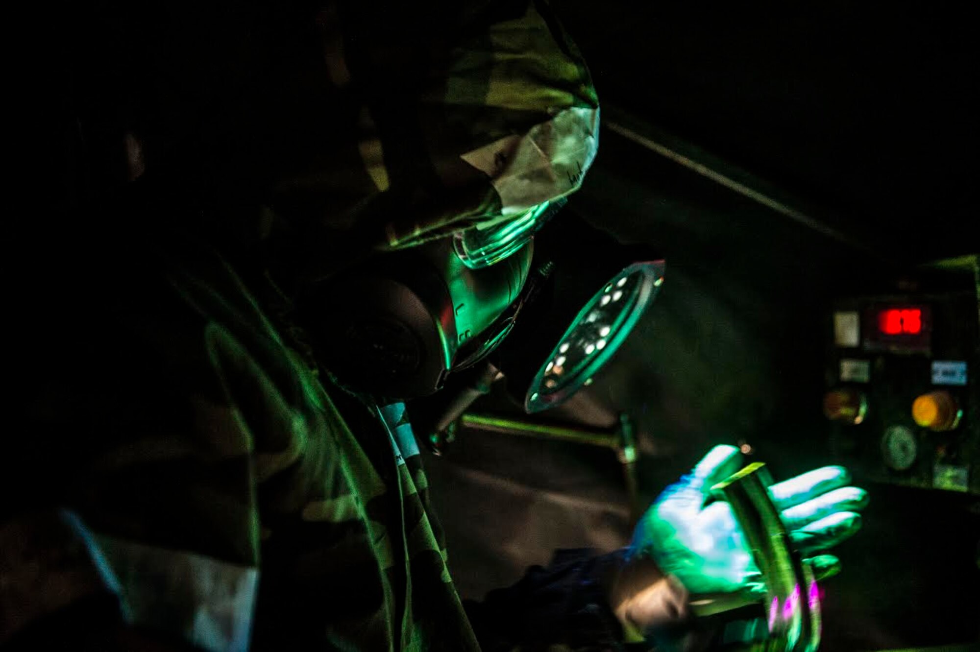 U.S. Air Force Airman 1st Class Colin Lanterman, 20th Equipment Maintenance Squadron non-destructive inspection (NDI) apprentice, inspects a part while in full mission oriented protective posture (MOPP) gear at Shaw Air Force Base, S.C., Jan. 15, 2019.