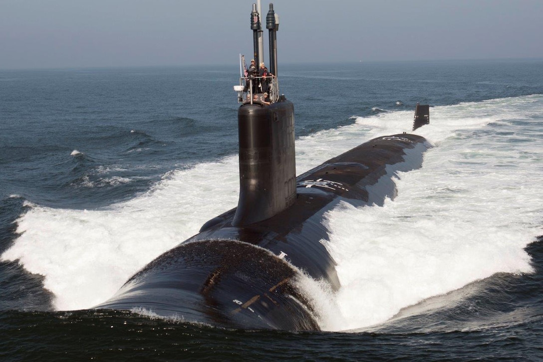 A submarine surfaces in the ocean.