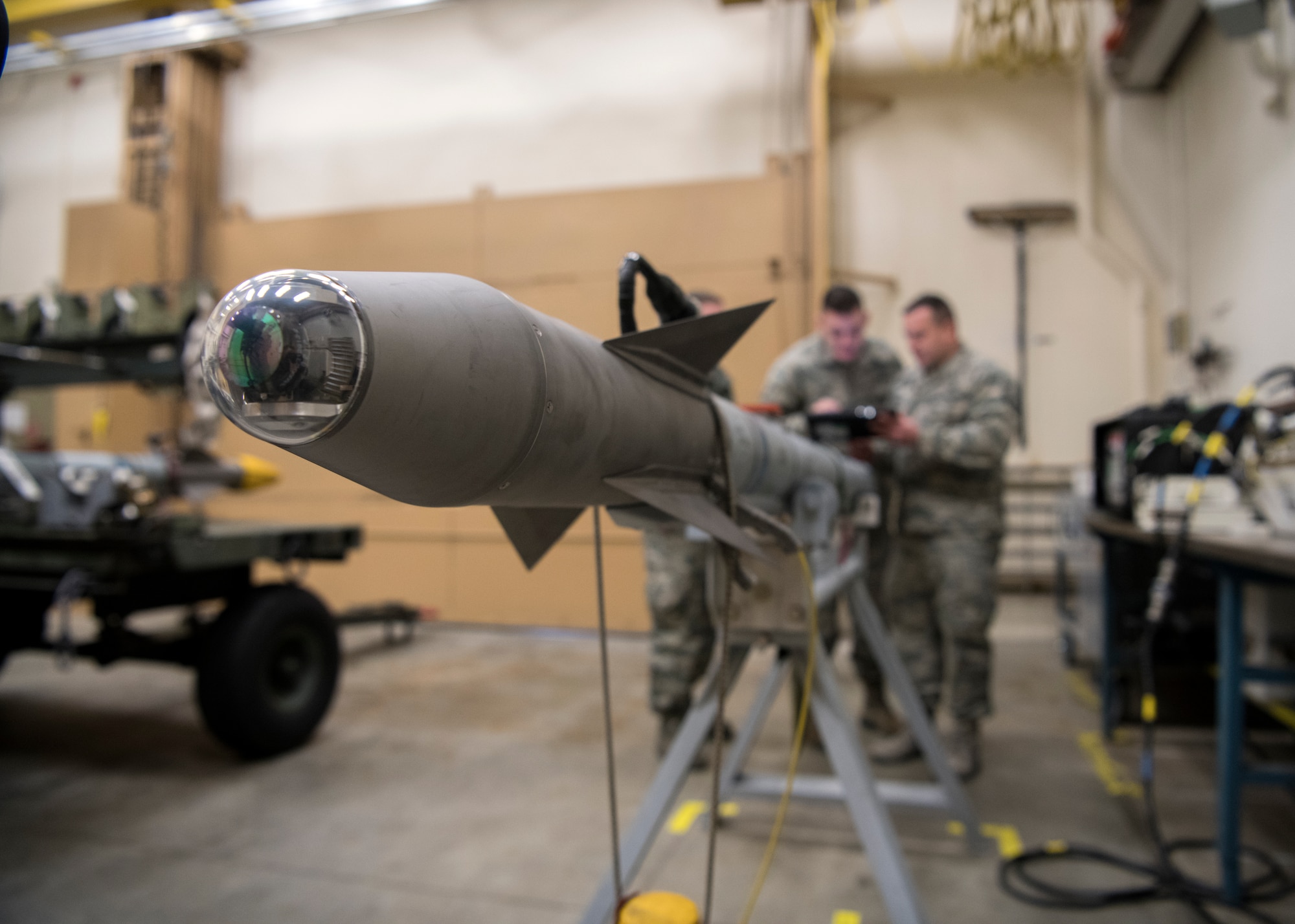 Senior Airman Alec Leavitt, Airman 1st Class Nick Burns, and Master Sgt. Ken McElroy, 104th Munitions Flight ordnance mechanics, prepare to conduct a 60 day inspection on a Captive Air Training Missile 9X-2, Jan. 16, 2018, at Barnes Air National Guard Base, Massachusetts. The CATM 9X-2 is the primary munition used for air to air combat by the F-15 Eagles at the 104th Fighter Wing. (U.S. Air National Guard photo by Airman 1st Class Randy Burlingame)