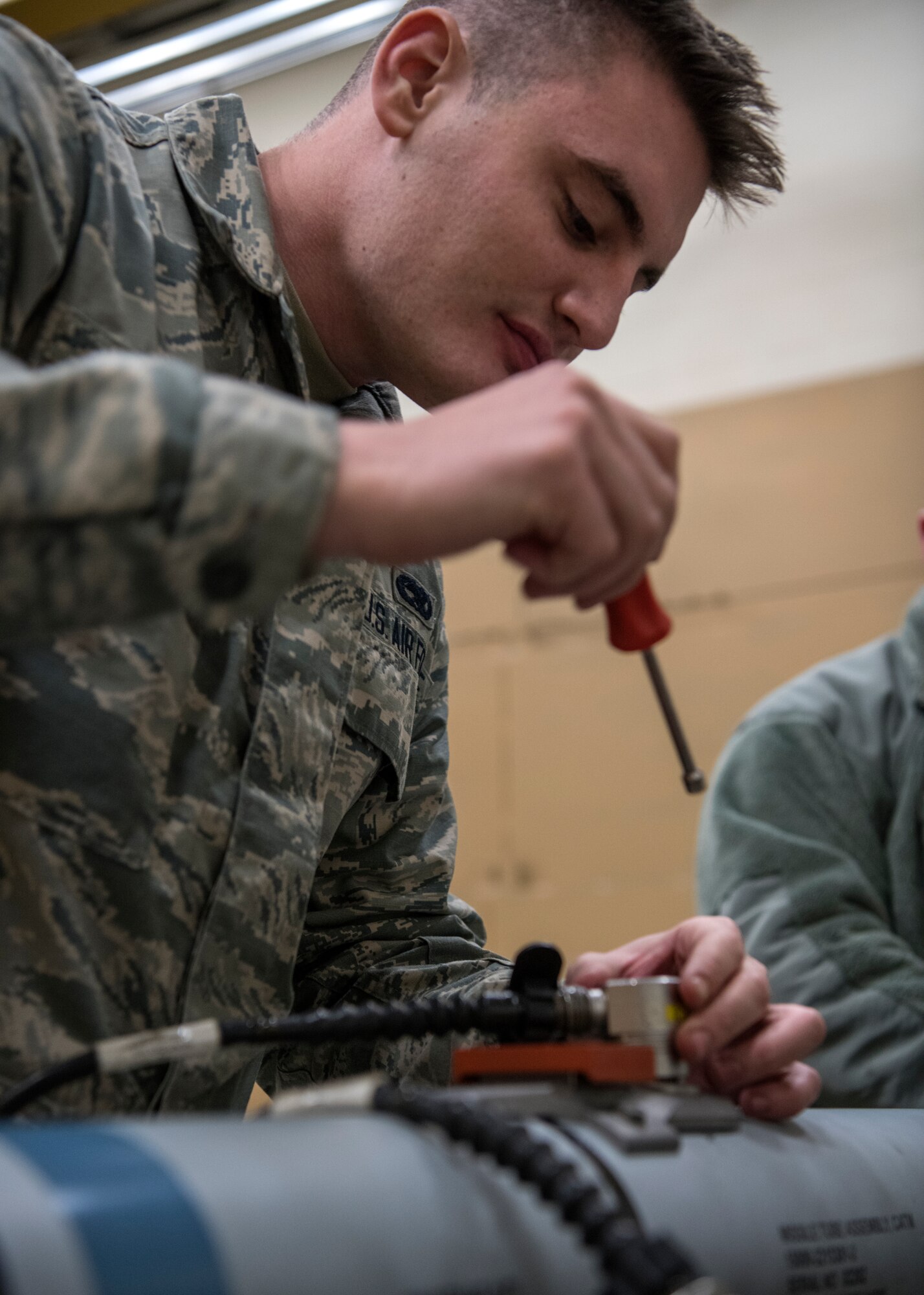 Airman 1st Class Nick Burns, 104th Munitions Flight ordnance mechanic, conducts a 60 day inspection on a Captive Air Training Missile 9X-2, Jan. 16, 2018, at Barnes Air National Guard Base, Massachusetts. The CATM 9X-2 is used almost daily by F-15 Eagles at the 104th Fighter Wing. (U.S. Air National Guard photo by Airman 1st Class Randy Burlingame)