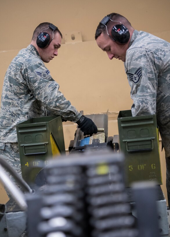 Staff Sergeant Tim Bennett and Airman 1st Class Donoven Joseph, 104th Munitions Flight Airmen, load 20mm ammunition into a Universal Ammunition Loading System Jan. 16, 2018, at Barnes Air National Guard Base, Massachusetts. The UAL will later be used by weapons Airmen to load an F-15 Eagle's weapons system. (U.S. Air National Guard photo by Airman 1st Class Randy Burlingame)