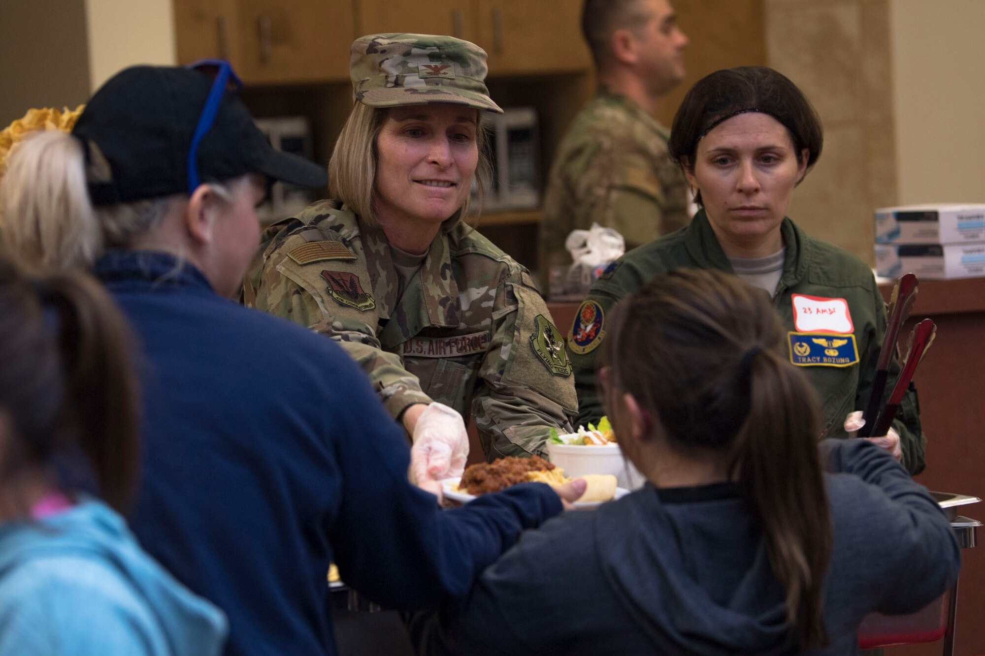 Col. Tiffany Morgan, 23d Medical Group commander, sets a plate on a tray during a deployed spouses dinner, Jan. 15, 2019, at Moody Air Force Base, Ga. The mission’s success depends on resilient Airmen and families who are prepared to make sacrifices with the support of their fellow Airmen, local communities and leadership. (U.S. Air Force photo by Airman Taryn Butler)