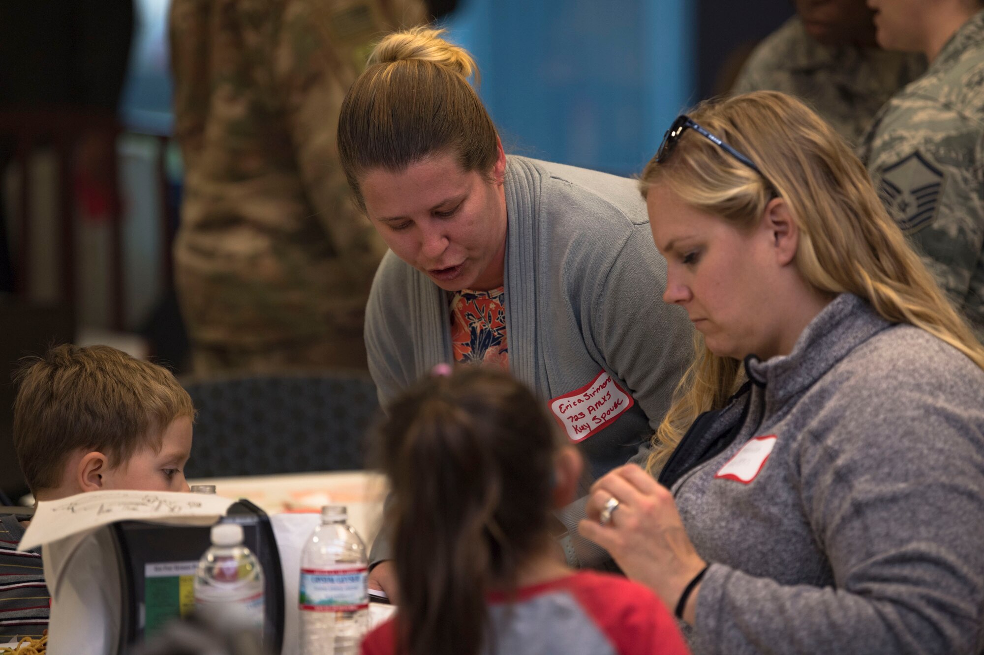 Erica Sirmons, 723d Aircraft Maintenance Squadron key spouse, helps a guest during a deployed spouses dinner, Jan. 15, 2019, at Moody Air Force Base, Ga. The mission’s success depends on resilient Airmen and families who are prepared to make sacrifices with the support of their fellow Airmen, local communities and leadership. (U.S. Air Force photo by Airman Taryn Butler)
