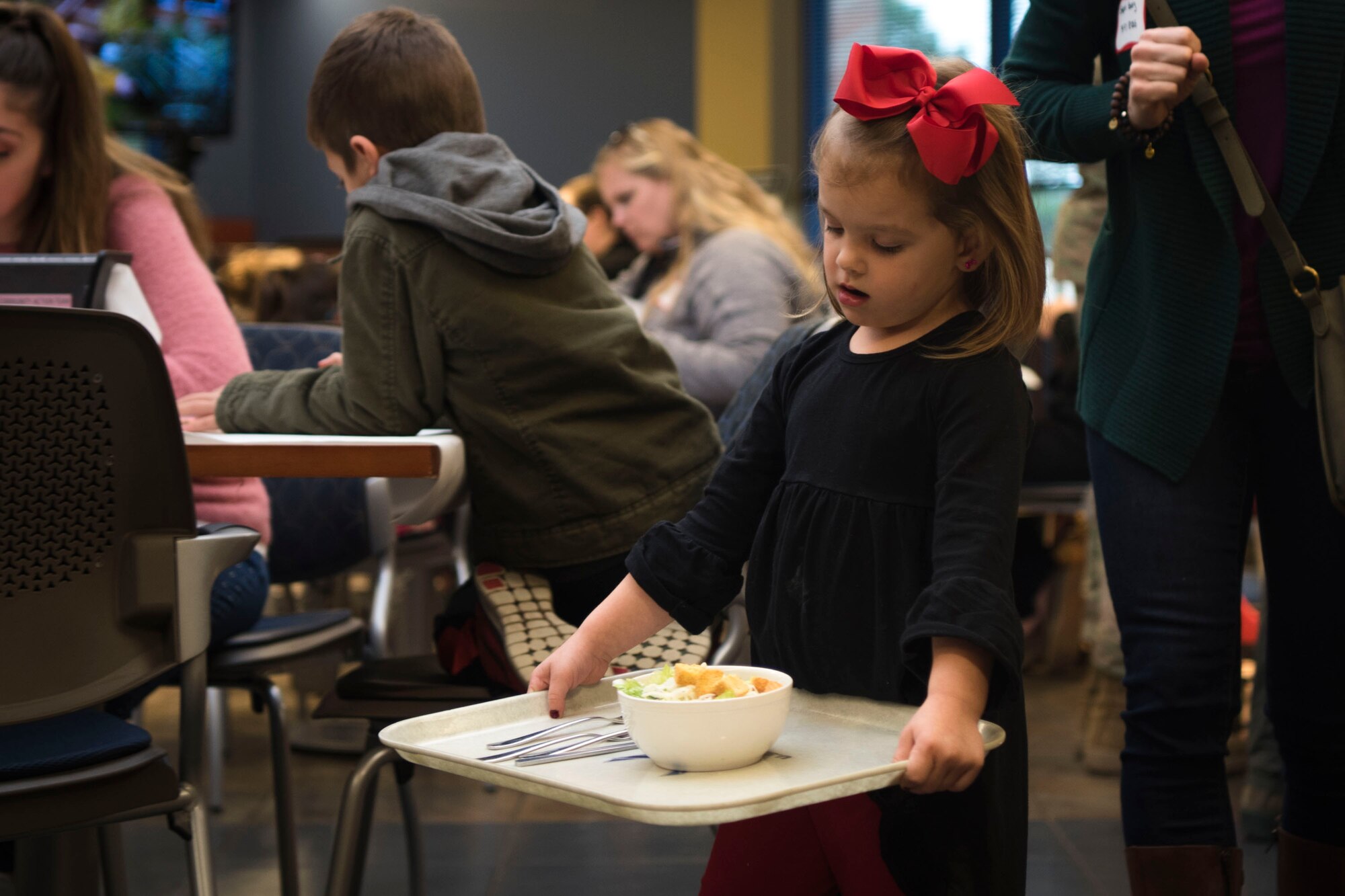 A guest carries her tray during a deployed spouses dinner, Jan. 15, 2019, at Moody Air Force Base, Ga. The mission’s success depends on resilient Airmen and families who are prepared to make sacrifices with the support of their fellow Airmen, local communities and leadership. (U.S. Air Force photo by Airman Taryn Butler)