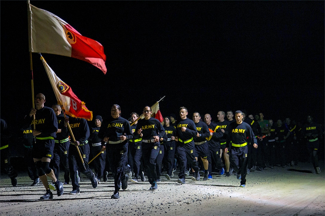 Soldiers run at night.