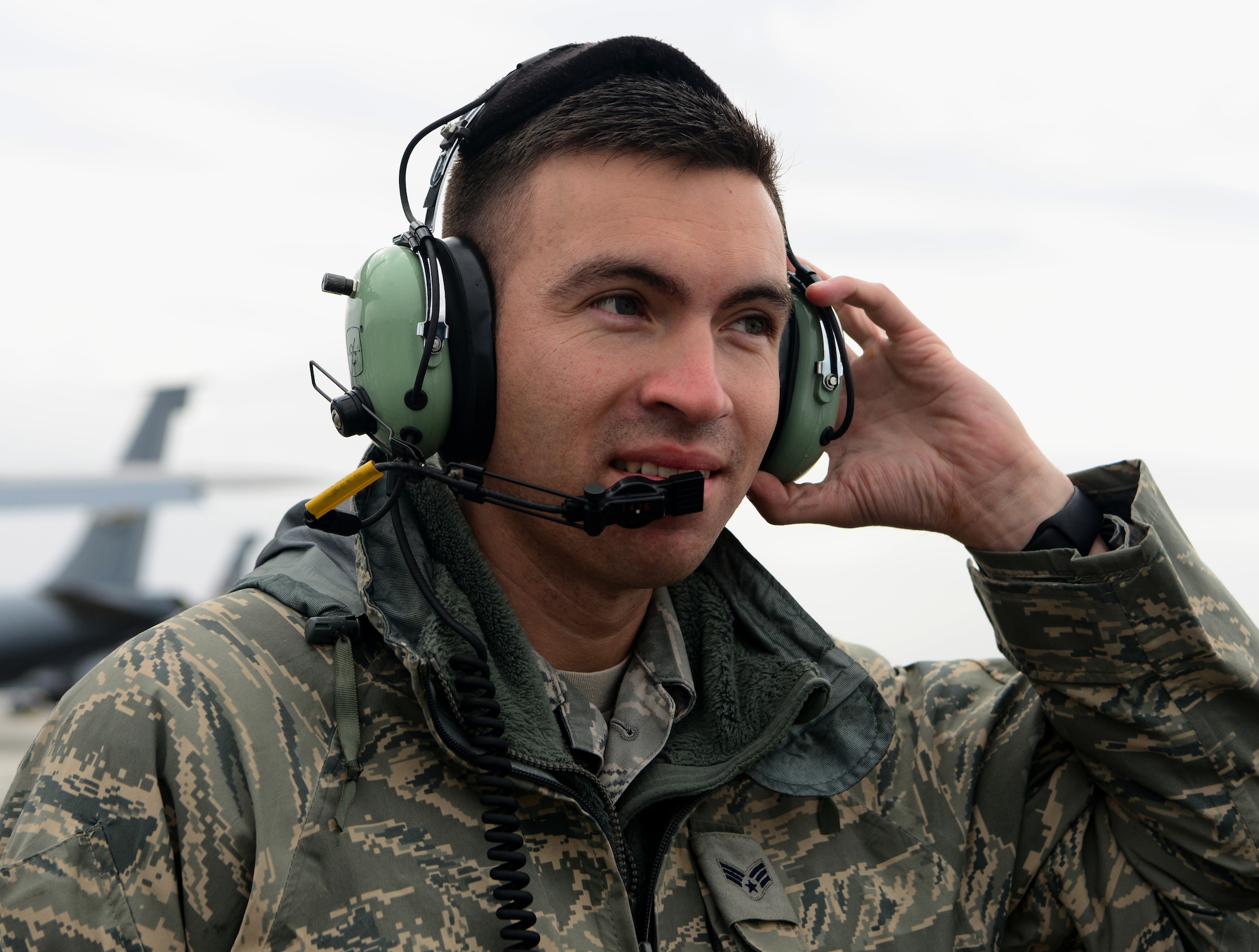 Senior Airman Luis Perfino, 940th Aircraft Maintenance Squadron crew chief, communicates with KC-135 Stratotanker pilots
