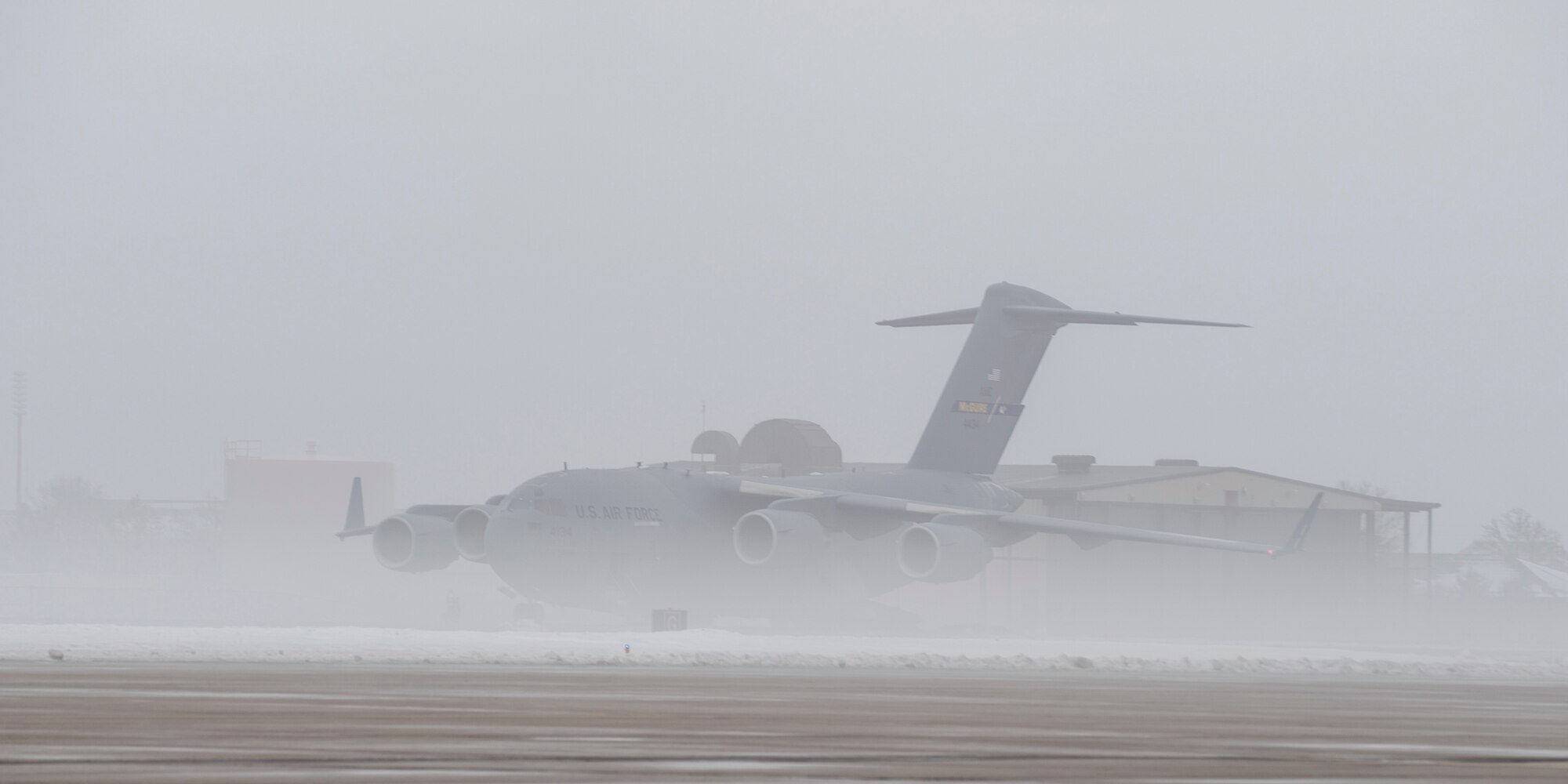 Fog surrounds a Joint Base McGuire-Dix-Lakehurst C-17 Globemaster III parked on the runway at Scott Air Force Base, Ill. Jan. 17, 2018. Scott AFB and the local community were affected by heavy fog which lowered the visibility to 1/8th of a statute mile and led to delays on the flight line. Scott is expected to have more snow over the weekend which could possibly lead to a similar situation.