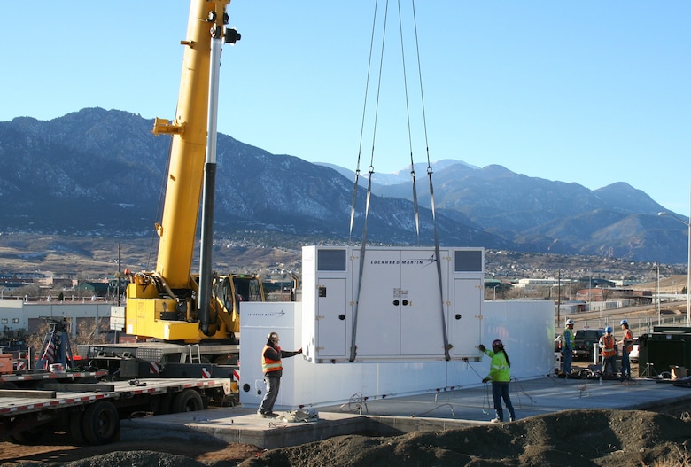 Workers install portions of the 8.5 megawatt-per-hour battery system at Fort Carson, Colorado. Huntsville Center’s Energy Savings Performance Contracting program coordinated the project designed to reduce peak electricity use costs, especially during the summer cooling season.