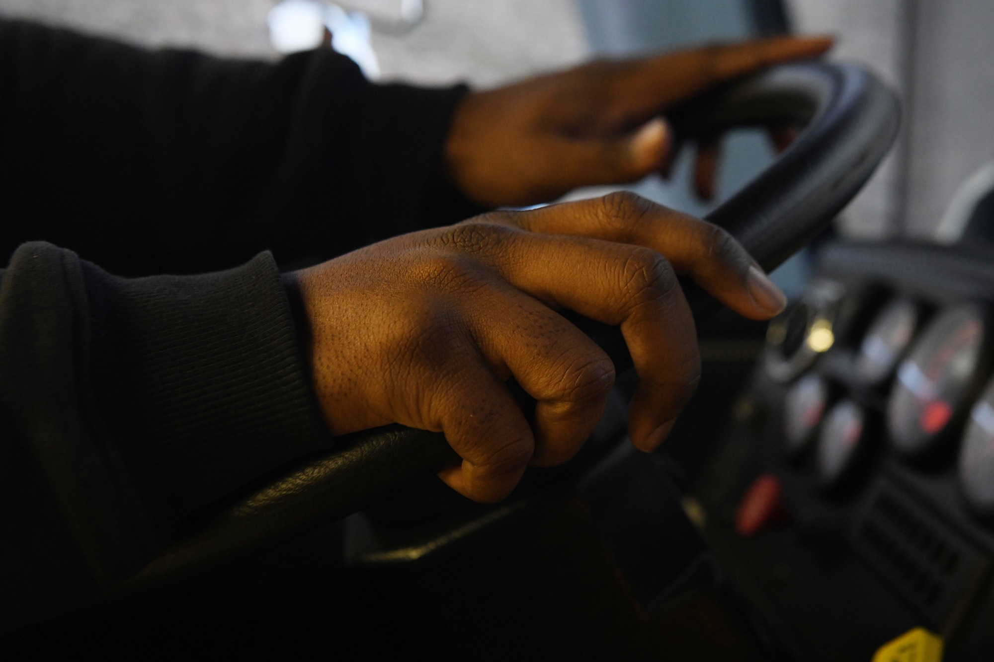 Jonathan Matthews, a firefighter assigned to the 97th AMW Fire Department, grips the steering wheel on a driving simulator Jan 15., 2019, at Altus Air Force Base, Okla. The simulator is used to help train vehicle operations while outdoor conditions are not ideal. (U.S. Air Force photo by Airman 1st Class Jeremy Wentworth)