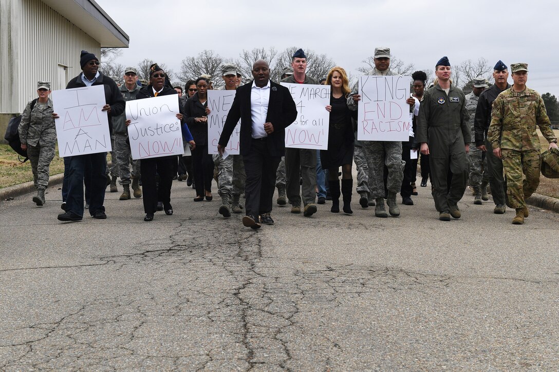 A crowd walks towards the camera.