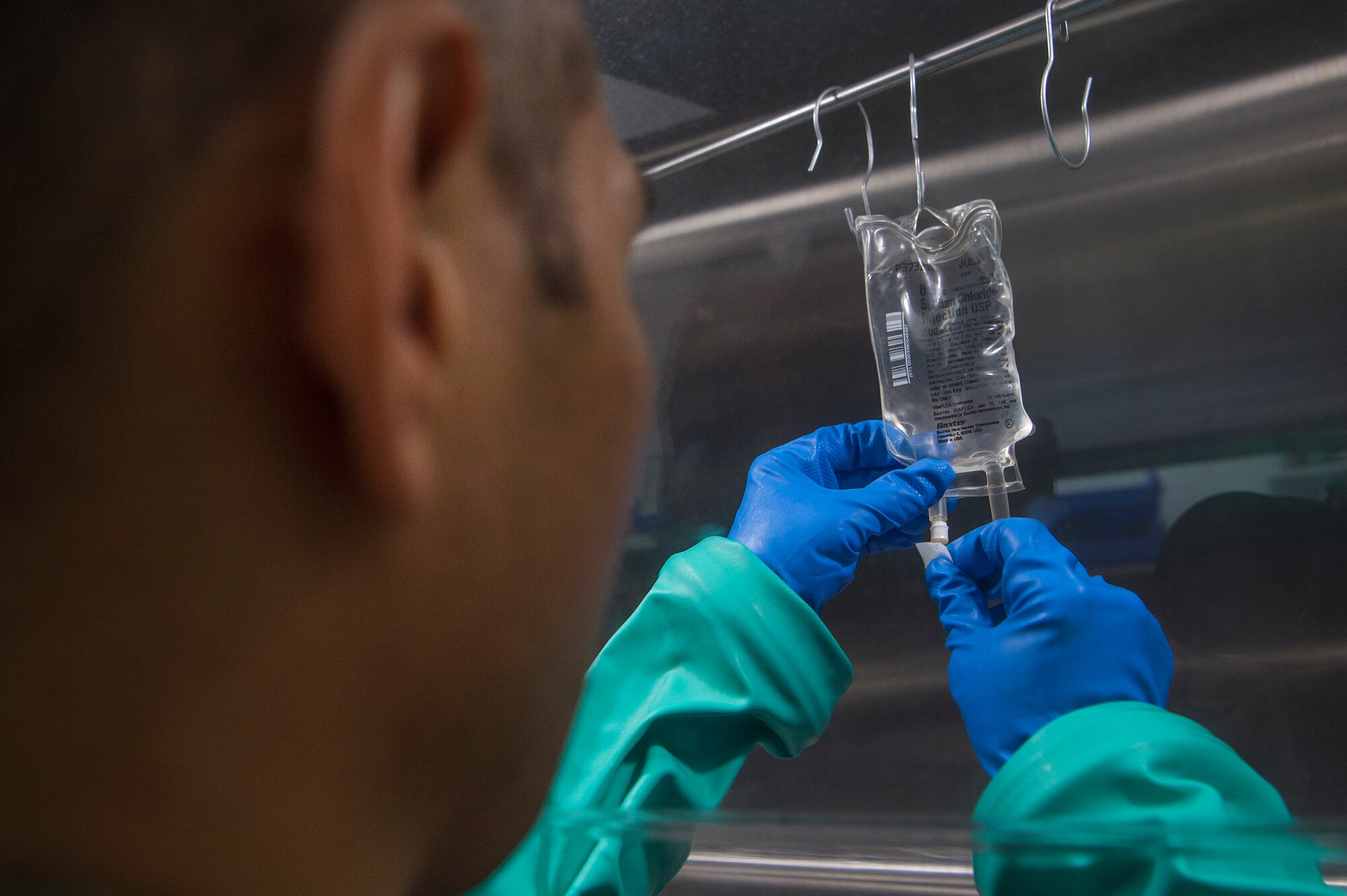 Tech. Sgt. Thoney Douangnoy, left, 379th Expeditionary Medical Group (EMDG) pharmacy operations NCO in charge, prepares compounded intravenous (IV) medications at the 379th EMDG pharmacy Jan. 15, 2019, at Al Udeid Air Base, Qatar. Airmen at Al Udeid’s pharmacy prepare compounded IV medications containing antibiotics for inpatient and air evacuated patients. (U.S. Air Force photo by Tech. Sgt. Christopher Hubenthal)