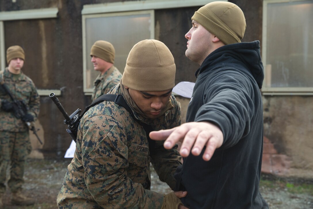 U.S. Marine Corps Pfc. J’Den Spencer with Combat Logistics Battalion 24, Combat Logistics Regiment 27, 2nd Marine Logistics Group, searches a simulated evacuee during evacuee control center training at Camp Davis South Training Area, North Carolina, Jan. 18, 2019. CLB-24 conducted the ECC training as part of a Marine Combat Readiness Evaluation in preparation for an upcoming deployment. (U.S. Marine Corps photo by Lance Cpl. Damion Hatch Jr.)