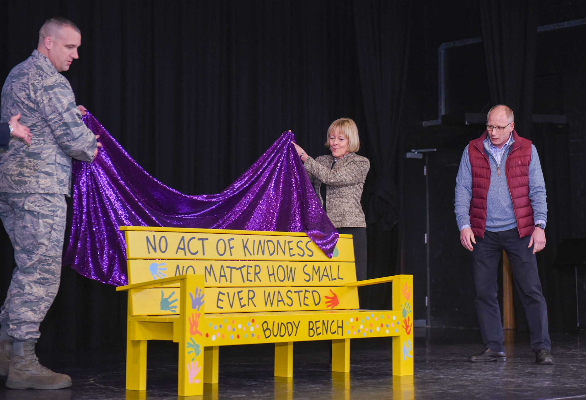 U.S. Air Force Col. Christopher Bromen unveils the new Buddy Bench at RAF Alconbury, United Kingdom, Jan.15, 2019. The new Buddy Bench has been placed at the base elementary school to promote kindness and healthy relationships within the school system. (U.S. Air Force photo by Airman 1st Class Jennifer Zima)