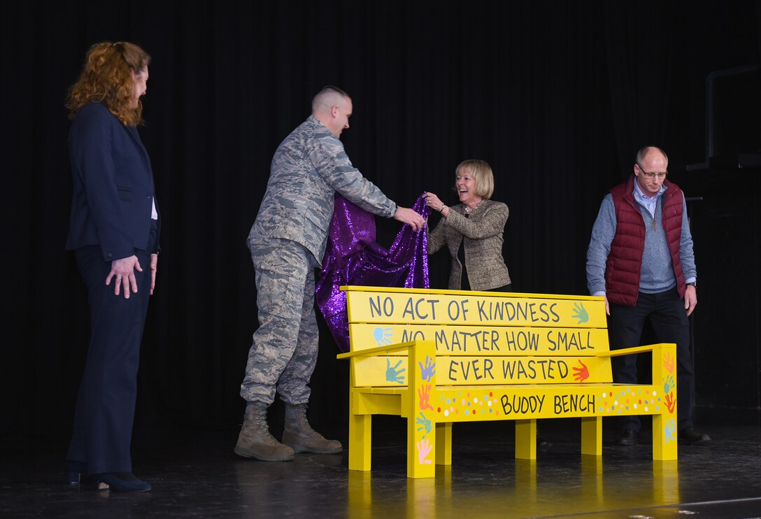 U.S. Air Force Col. Christopher Bromen unveils the new Buddy Bench at RAF Alconbury, United Kingdom, Jan.15, 2019. The new Buddy Bench has been placed at the base elementary school to promote kindness and healthy relationships within the school system. (U.S. Air Force photo by Airman 1st Class Jennifer Zima)