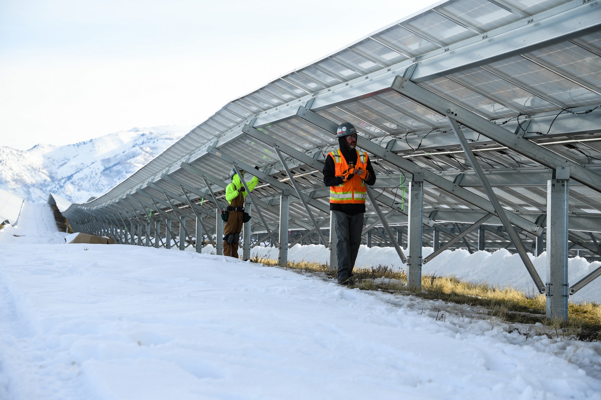 Bobby Southerland, right, and Jon Wall install electrical wiring clips onto the new solar array being installed at Hill Air Force Base, Utah, Jan. 9, 2018.