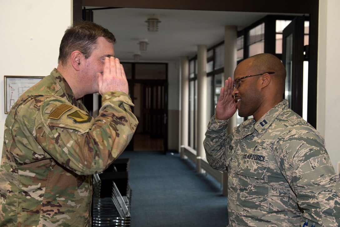U.S. Air Force Capt. Alex Johnson, 86th Airlift Wing chaplain (right), salutes U.S. Air Force Brig. Gen. Mark R. August, 86th AW commander, after being coined by August on Ramstein Air Base, Germany, Jan. 17, 2019. Johnson supports 14 units as their primary chaplain, while also preaching weekly at the Ramstein Chapel’s protestant service, and conducting counseling sessions. (U.S. Air Force photo by Staff Sgt. Jonathan Bass)