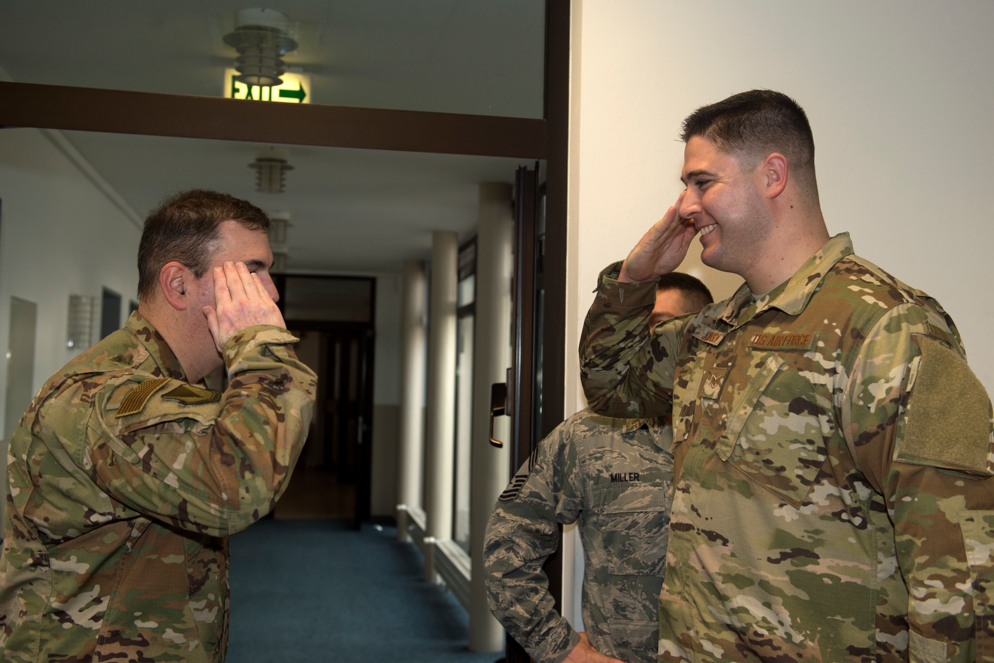 U.S. Air Force Staff Sgt. Jacob Johnson, 86th Airlift Wing non-commissioned officer in charge of education and training (right), salutes U.S. Air Force Brig. Gen. Mark R. August, 86th AW commander, after being coined by August on Ramstein Air Base, Germany, Jan. 17, 2019. Johnson is responsible for helping ensure the freedom of religion for Airmen and their families through spiritual care and counseling leadership. (U.S. Air Force photo by Staff Sgt. Jonathan Bass)