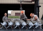 56th Equipment Maintenance Squadron munition Airmen load GBU-12 Paveway II’s onto a bomb pad at Luke Air Force, Ariz., Jan. 15, 2019.