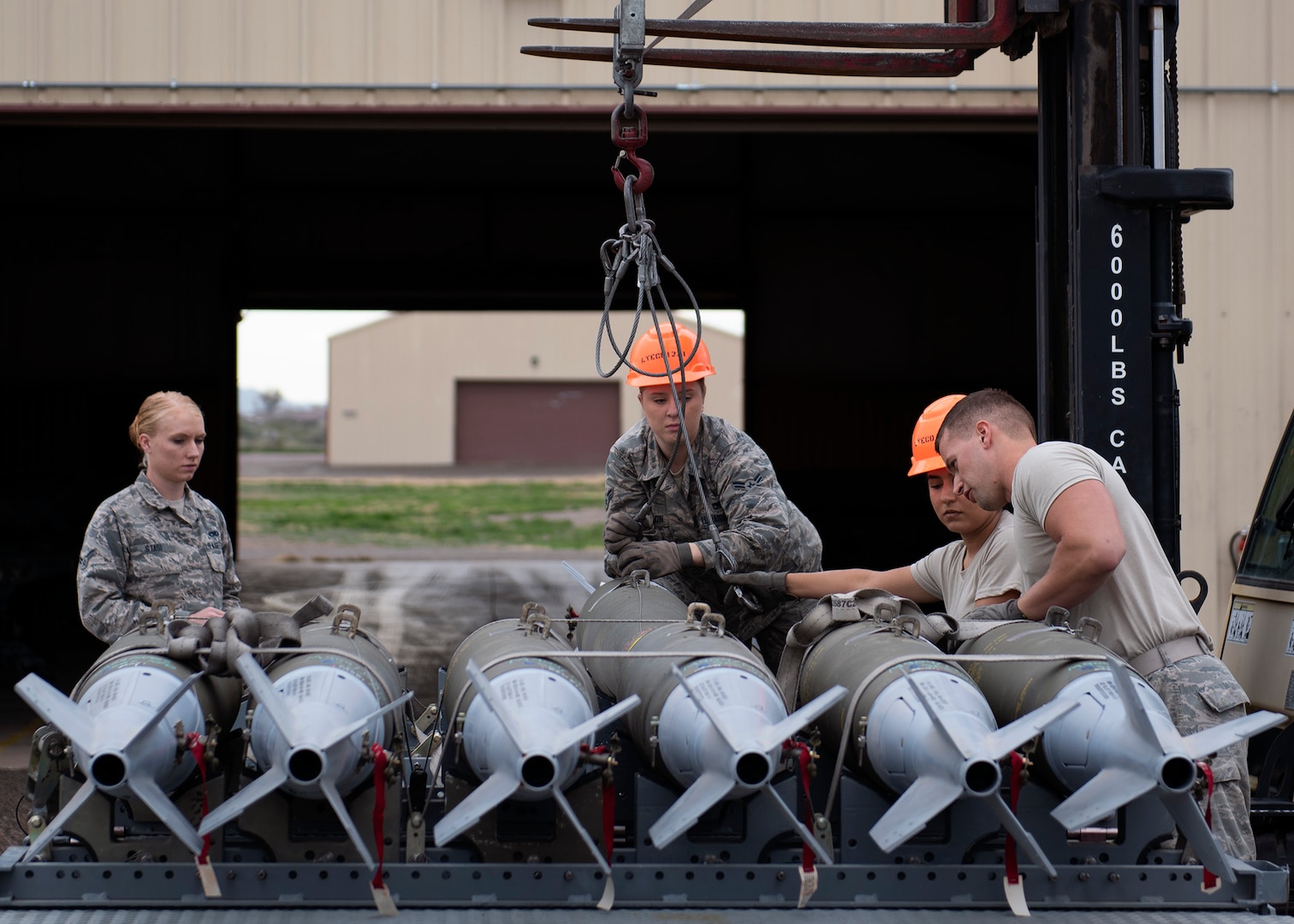 56th Equipment Maintenance Squadron munition Airmen load GBU-12 Paveway II’s onto a bomb pad at Luke Air Force, Ariz., Jan. 15, 2019.