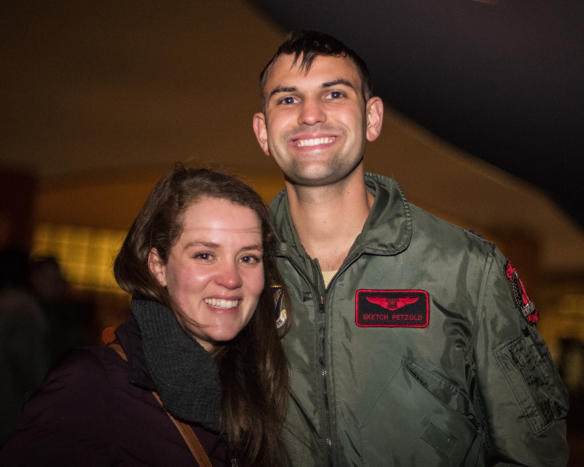 After returning from a deployment, Capt. Zach Petzold, 96th Bomb Squadron electronic warfare officer, and his wife pose for a photo at Barksdale Air Force Base, La., Jan. 16, 2019. Petzold and his team deployed to Andersen Air Force Base, Guam for six months in support of Continuous Bomber Presence. (U.S. Air Force photo by Airman 1st Class Lillian Miller)