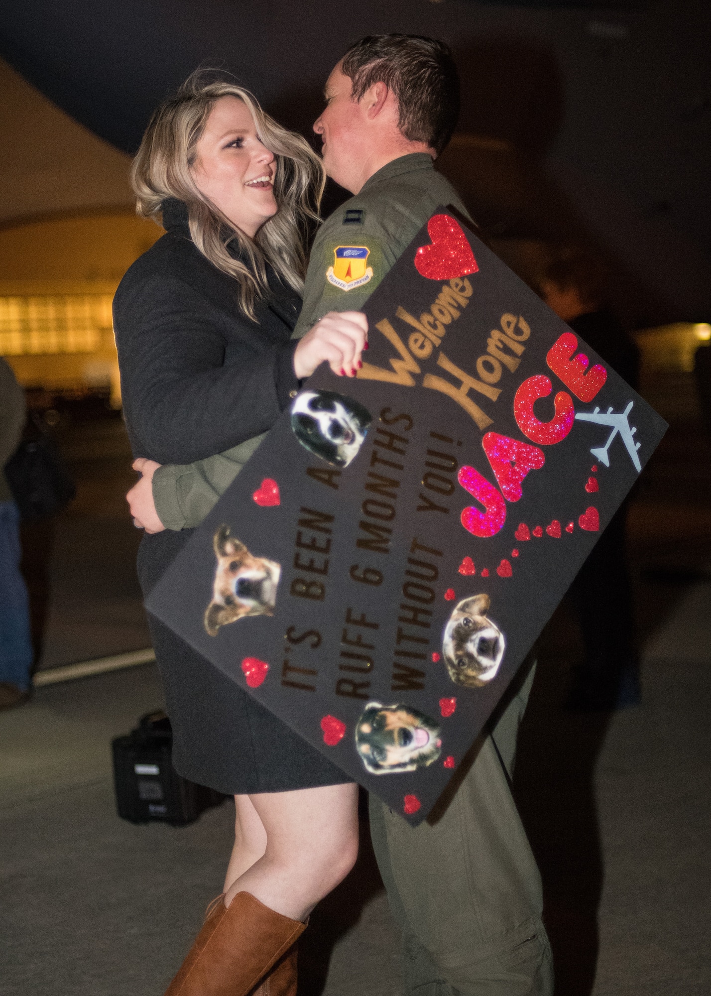 Capt. Jace Muehlenthaler, 96th Bomb Squadron weapons system officer, embraces his wife after returning from a deployment at Barksdale Air Force Base, La., Jan. 16, 2019. Muehlenthaler and his team deployed to Andersen Air Force Base, Guam for six months in support of Continuous Bomber Presence. (U.S. Air Force photo by Airman 1st Class Lillian Miller)
