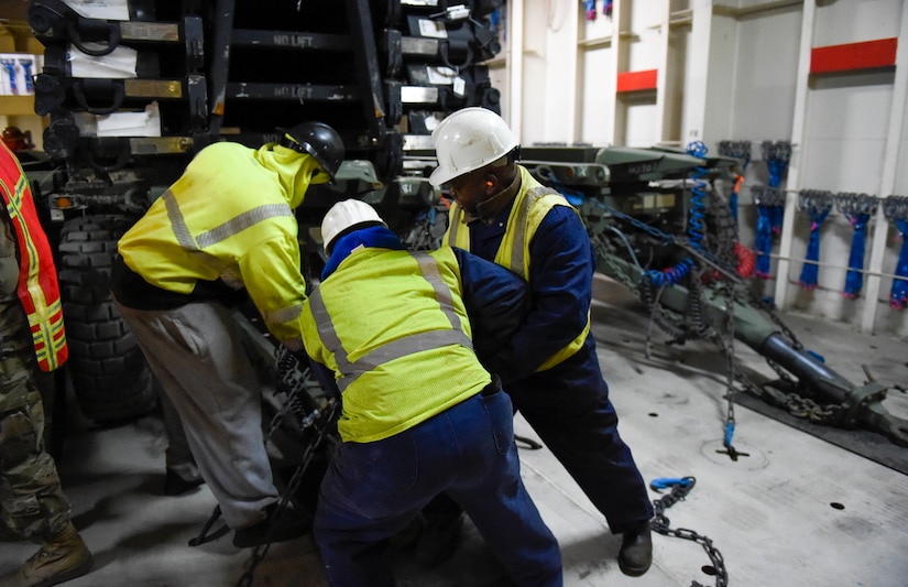 Civilian contractors working with the 841st Transportation Battalion secure equipment within the MV Green Cove Jan. 11, 2019, in preparation for transport at Wharf Alpha on Joint Base Charleston, S.C., in continuing support of Atlantic Resolve.