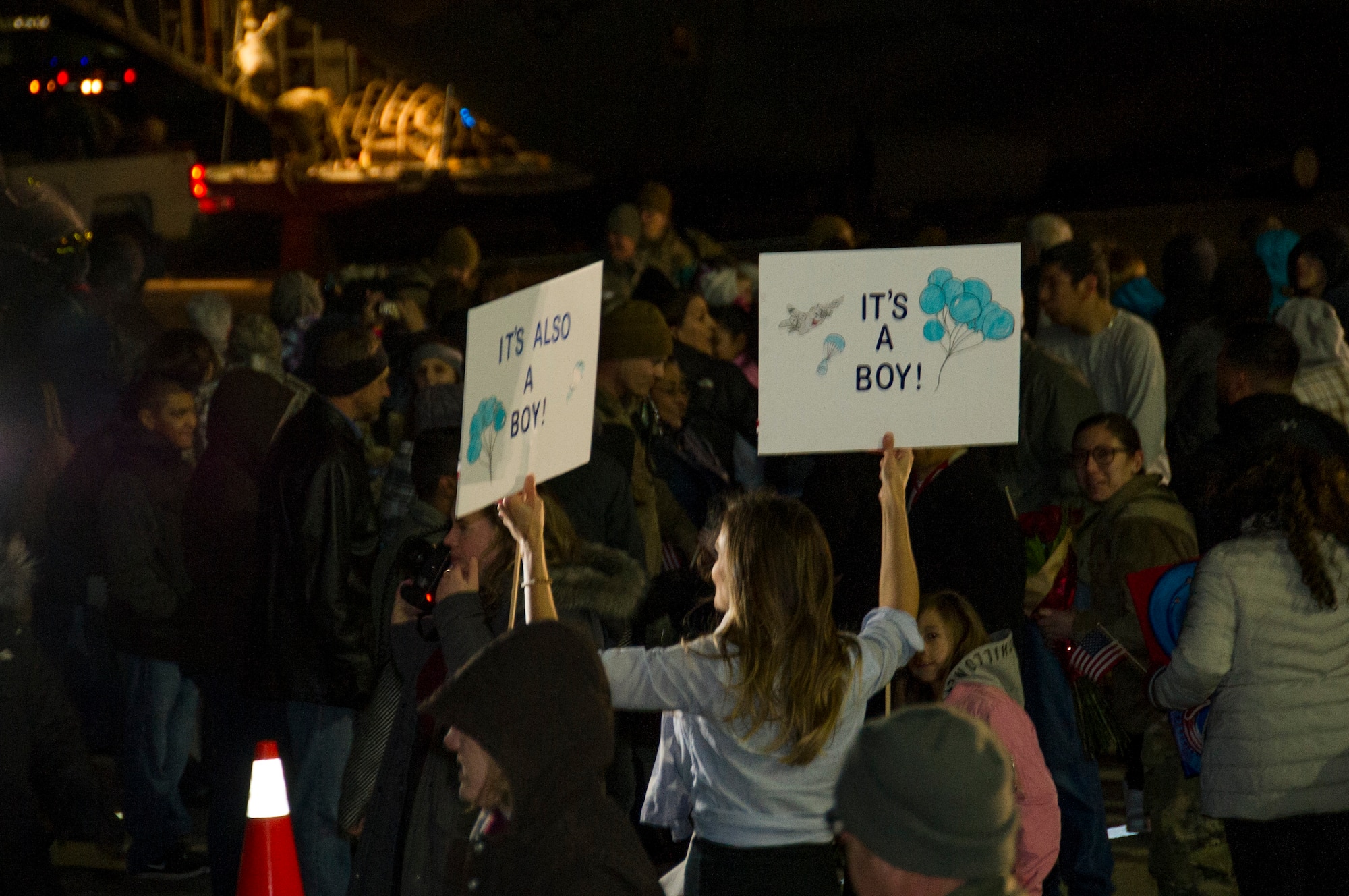 Friends and family cheer as 302nd Airlift Wing reservists approach after landing at Peterson Air Force Base, Colorado, Jan. 18, 2019.