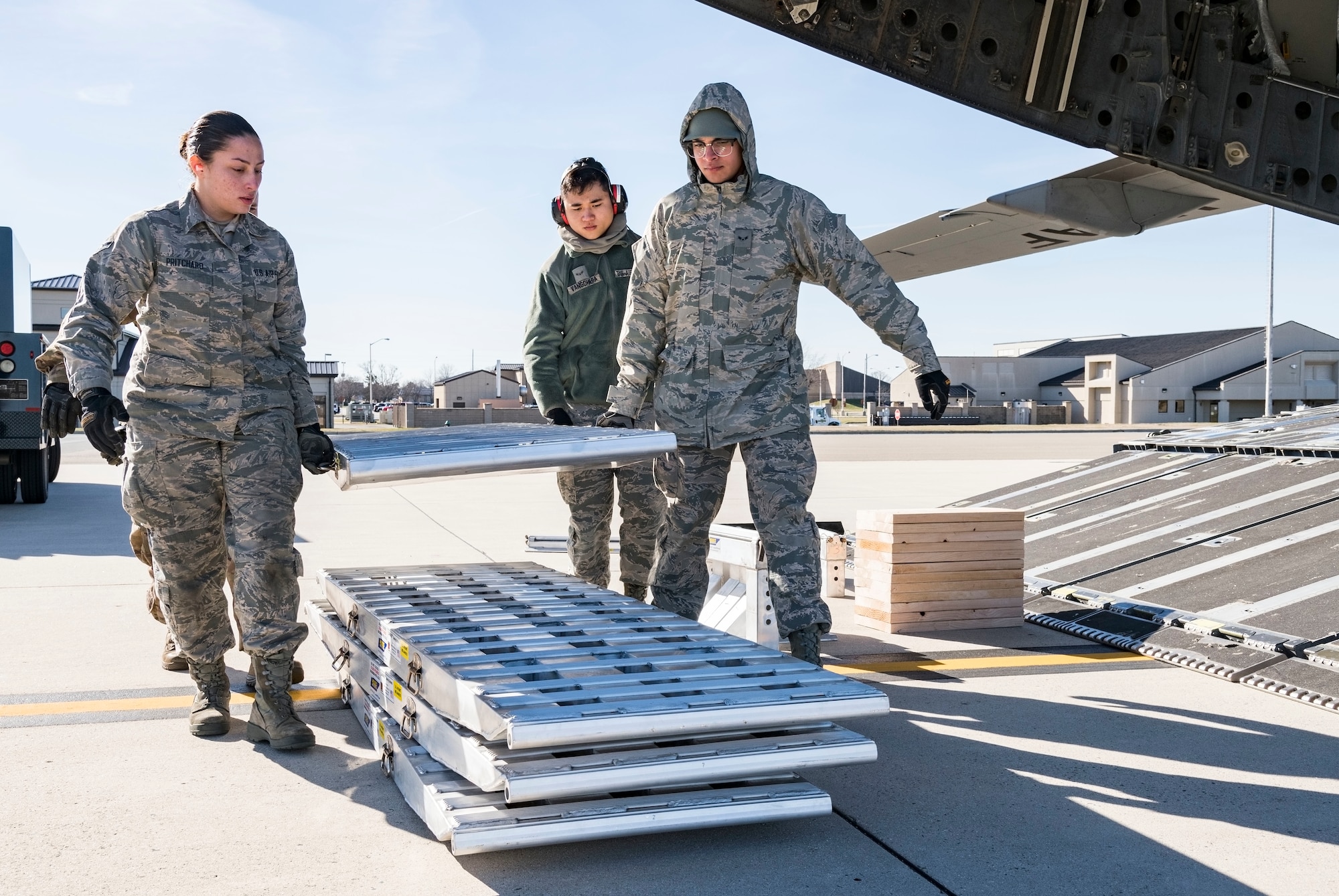 Ramp operations specialists assigned to the 436th Aerial Port Squadron carry the ramp sections of DOMOPS Airlift Modular Approach Shoring Jan. 11, 2019, at Dover Air Force Base, Del. The modular shoring was used to upload five vehicles belonging to the Delaware National Guard's 31st Civil Support Team, Weapons of Mass Destruction headquartered in Smyrna, Del. The vehicles and team members were airlifted by a C-17 to support the Florida National Guard during a large-scale training exercise Jan. 14-18. The 31st CST maintains the capability to mitigate the consequences of any WMD or Nuclear, Biological, and Chemical event, whether natural or man-made. They are experts in WMD effects and NBC defense operations. (U.S. Air Force photo by Roland Balik)