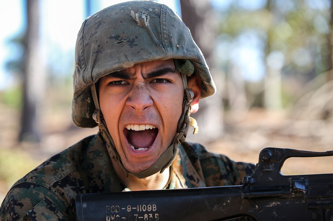 A Marine yells a command to his fire team.