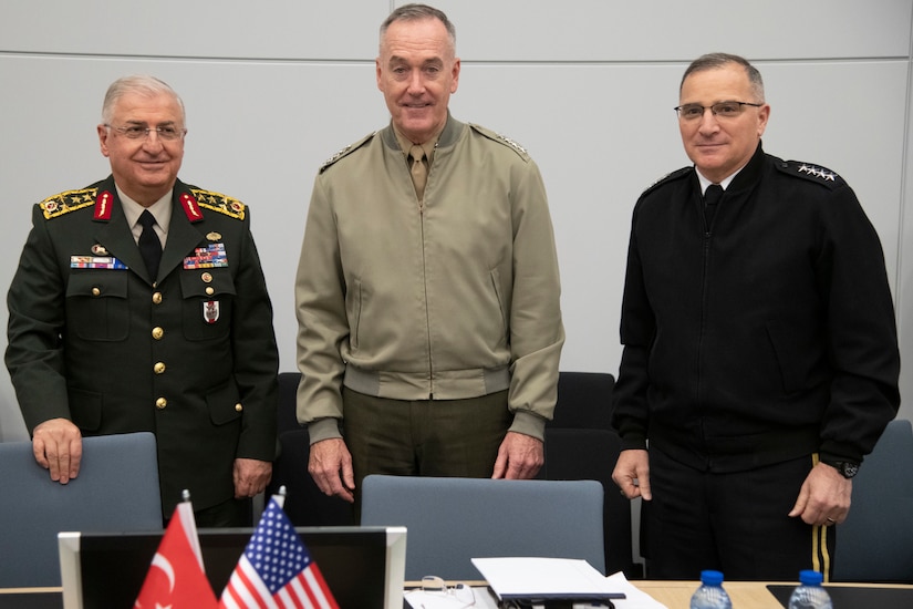 Three senior officers prepare for a meeting