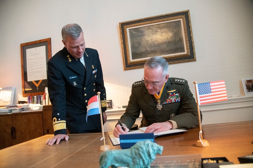 Joint Chiefs chairman signs guest book in The Hague, Netherlands