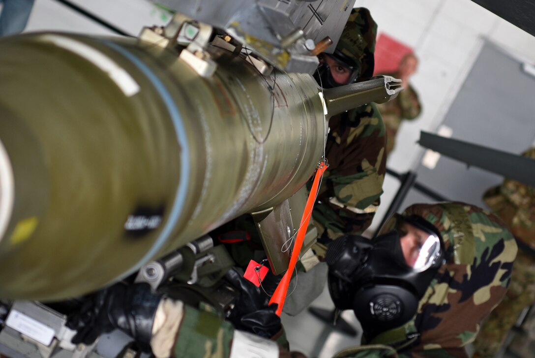 U.S. Air Force Airman 1st Class Levi Brady, 20th Aircraft Maintenance Squadron, 79th Aircraft Maintenance Unit weapons loader, left, and Staff Sgt. Dylan Zamminer, 20th Aircraft Maintenance Squadron, 77th Aircraft Maintenance Unit weapons load team chief, load a munition during a quarterly load crew competition at Shaw Air Force Base, S.C., Jan. 18, 2019.