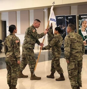 Guidon hand-off at the Change of Command ceremony for Columbus Medical Recruiting Company