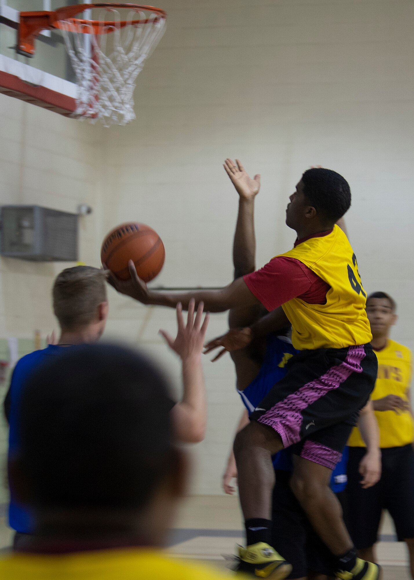 WSSS-Lopez guard Airman 1st Class Yaukis Cole drives by AFRL guard 1st Lt. Brennan Taylor in an intramural basketball contest at Kirtland Air Force Base, N.M., Jan. 17, 2019. Cole and WSSS-Lopez promised an intramural basketball championship this season, but did not find success against AFRL, losing 41-47. (U.S. Air Force photo by Staff Sgt. J.D. Strong II)