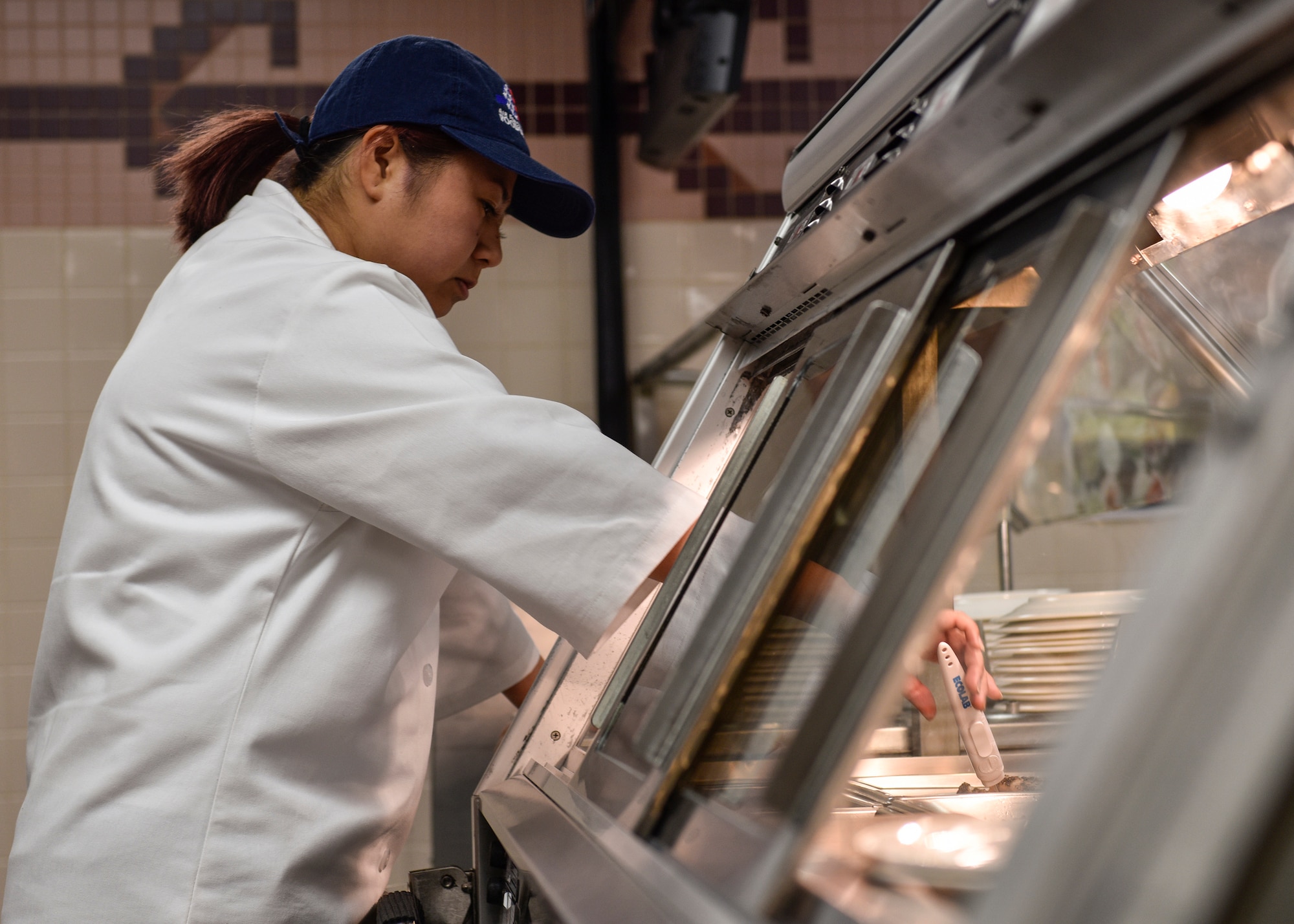 Kathleen Kato, Hennessy Traveler, checks the internal temperature of entrees offered at the Thunderbird Inn at Kirtland Air Force Base, N.M., Jan. 22, 2019. The Thunderbird Inn, along with two other dining facilities in the western region, were selected to be evaluated for the Hennessy Award. (U.S. Air Force photo by Airman 1st Class Austin J. Prisbrey)