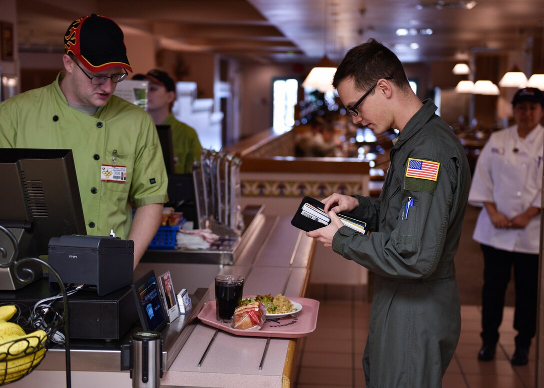 A patron of Thunderbird Inn pays for his lunch at Kirtland Air Force Base, N.M., Jan. 22, 2019. The Hennessy Travelers will evaluate two more dining facilities and then determine an overall winner for the Hennessy Award in the western region. (U.S. Air Force photo by Airman 1st Class Austin J. Prisbrey)