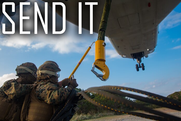 Landing support specialist attach an apex to an MV-22B Osprey hook during helicopter support team training at Camp Hansen, Okinawa, Japan, Jan. 14, 2019. Landing Support Company, 3rd Transportation Support Battalion, Combat Logistics Regiment 3, 3rd Marine Logistics Group supported Marine Medium Tiltrotor Squadron 265, Marine Aircraft Group 36, 1st Marine Aircraft Wing during external lift training, which ensures pilots and landing support specialists are able to communicate as well as transport gear from one location to another. (U.S. Marine Corps Photo by Cpl. André T. Peterson Jr.)
